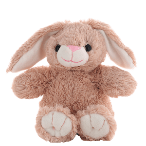 A stuffed bunny rabbit is sitting on the ground.