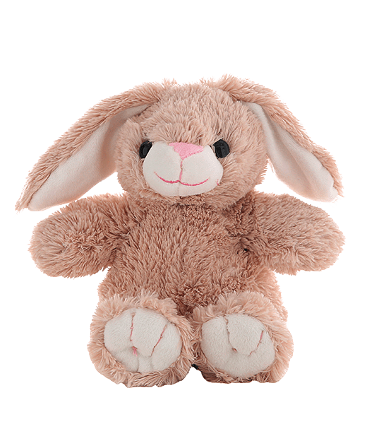 A stuffed bunny rabbit is sitting on the ground.