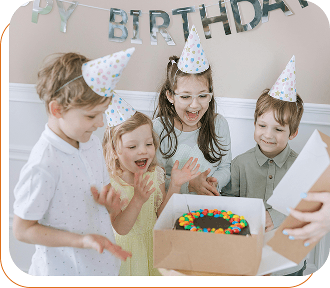 A group of children standing around a birthday cake.