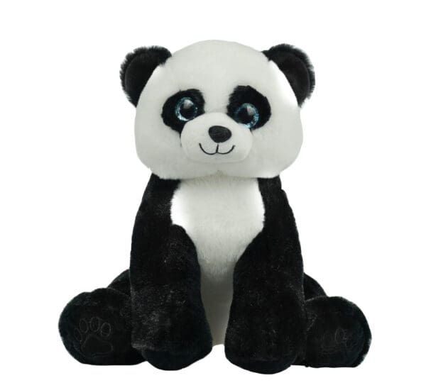 A stuffed panda bear sitting on top of the ground.