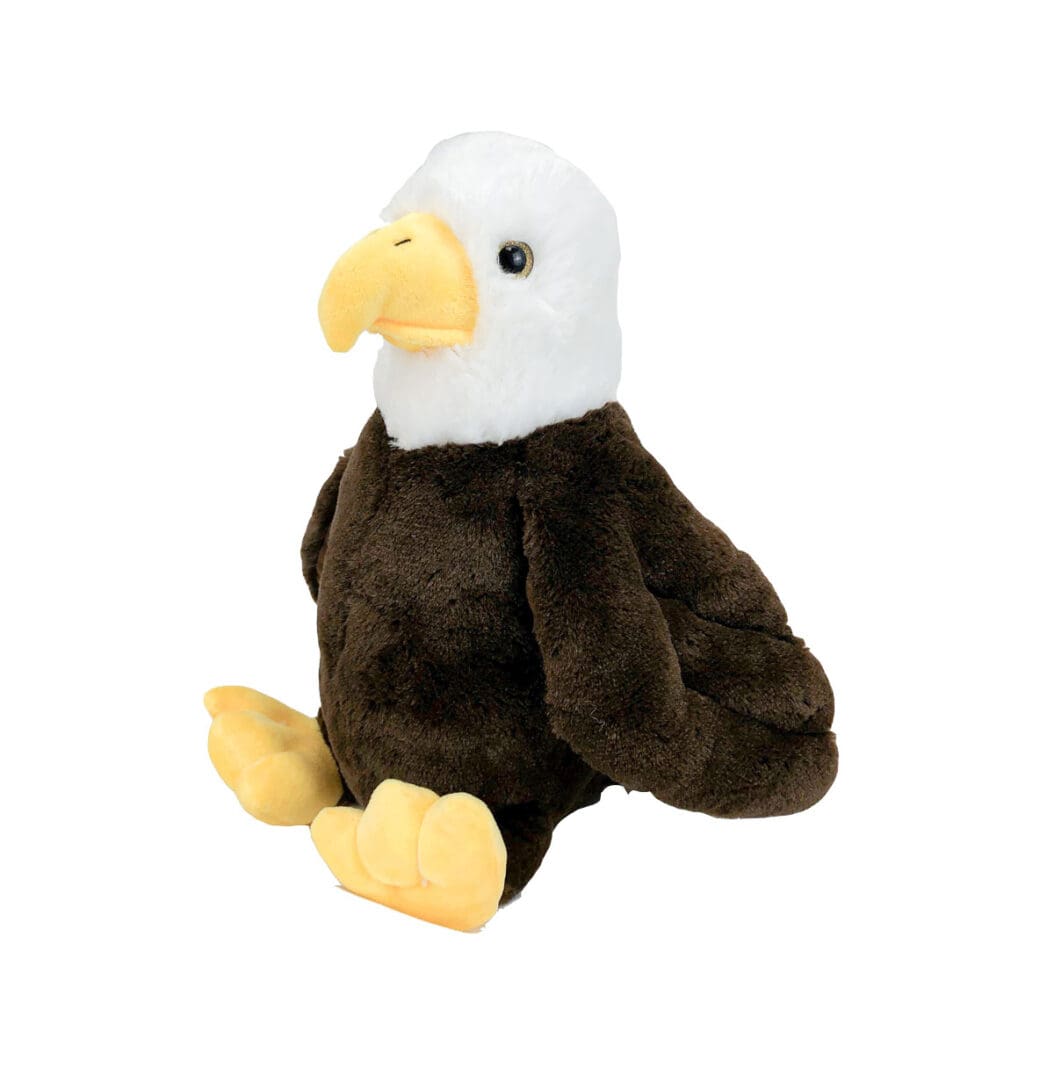 A stuffed eagle sitting on top of a white and brown bird.