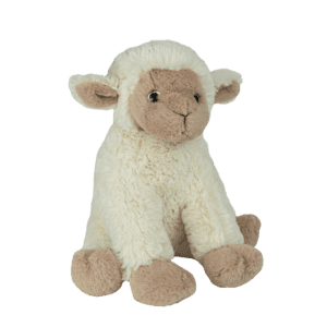 A stuffed lamb sitting on top of a green background.