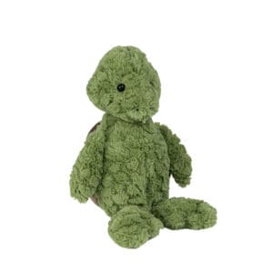 A green teddy bear sitting on top of the ground.