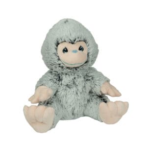 A stuffed monkey is sitting down and looking at the camera.