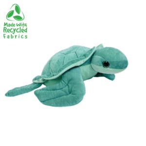 A stuffed turtle is sitting on the ground.