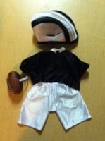 A black shirt and white shorts outfit with a football helmet.