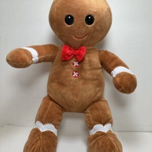 A stuffed gingerbread man with red bow tie.