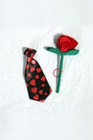 A tie and rose on the table