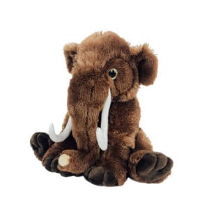 A stuffed animal elephant with tusks sitting on the ground.