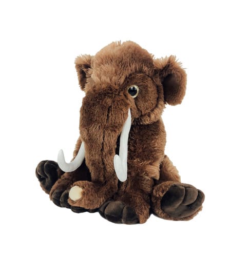 A stuffed animal elephant with tusks sitting on the ground.