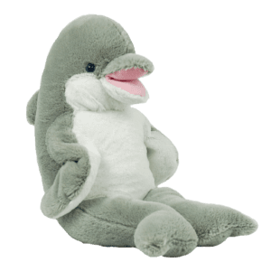 A stuffed dolphin sitting on top of a green background.