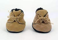 A pair of baby shoes on the ground