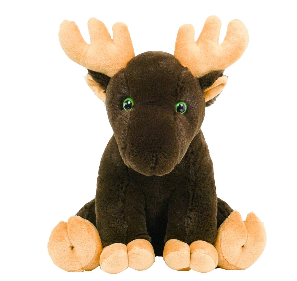 A stuffed animal moose sitting on top of the ground.