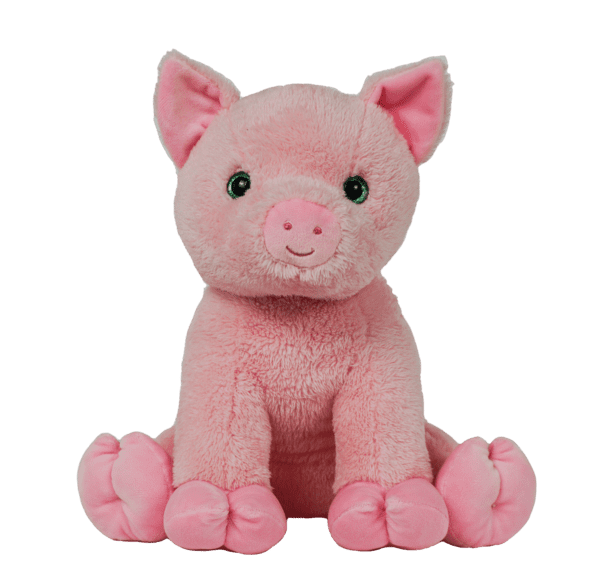 A pink stuffed pig sitting on top of a green background.