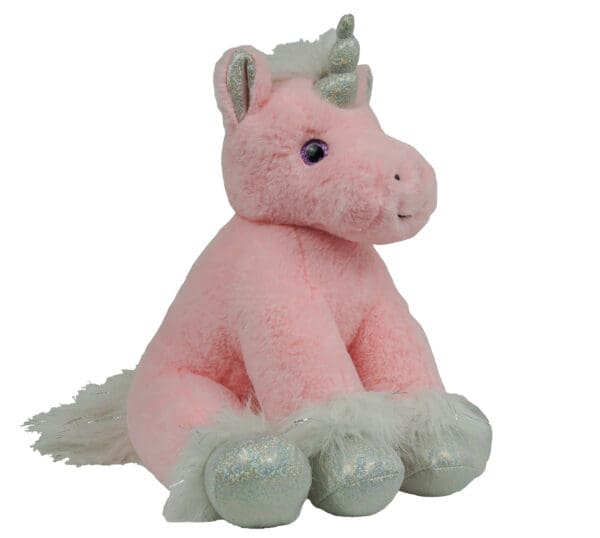 A pink unicorn sitting on top of a white table.