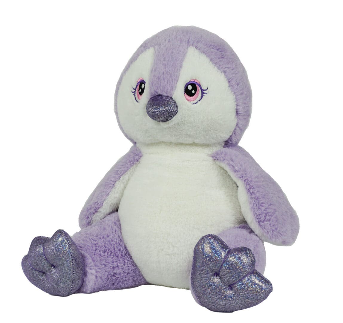 A purple and white stuffed penguin sitting on top of a table.