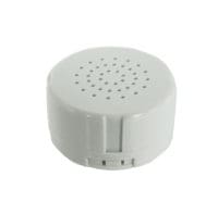 A white round speaker sitting on top of a table.