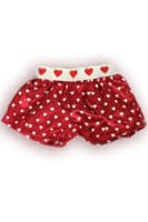 A pair of red shorts with white polka dots and hearts.