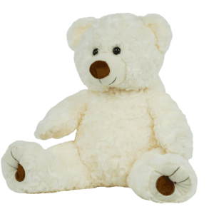 A white teddy bear sitting on top of a green background.