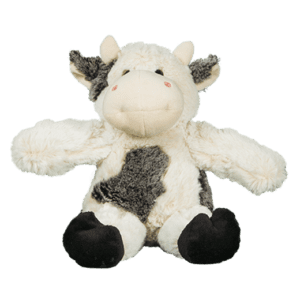 Plush cow toy on black background.